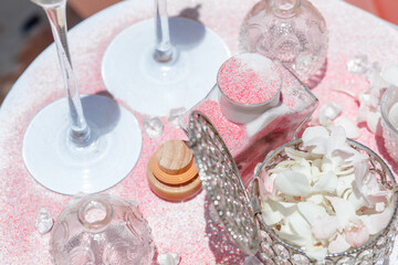 Beach wedding ceremony on a tropical island. 
Wedding paraphernalia in nude shades, tropical light flowers and sea sand.  Phuket, Thailand.