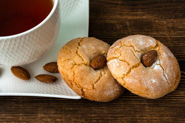 Gluten free italian cookies and a cup of tea. Almond cookies and a cup of tea. Sicilian traditional almond biscuits. Biscotti di mandorla siciliani.