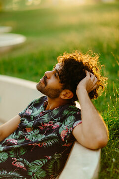 Portrait of a young guy with a beard and a flamingo shirt.