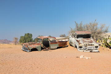 Abandoned car wrecks on the edge of desert Namib-Naukluft National Park in the Solitaire, Namibia
