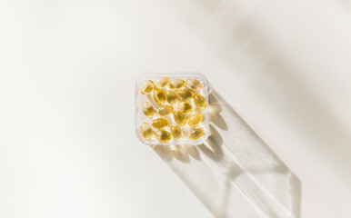 Capsules pills organic vitamins fish oil meds on white background.. Diet nutrition and healthy...