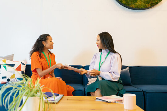 Businesswomen talking together on a sofa