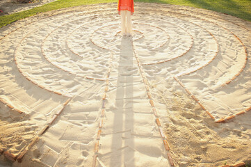 Woman standing in the center of a meditation labyrinth