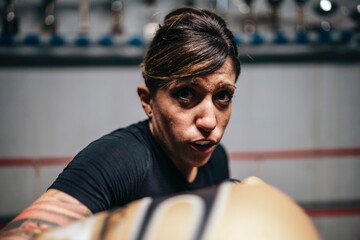 Aggressive sportswoman punching at camera