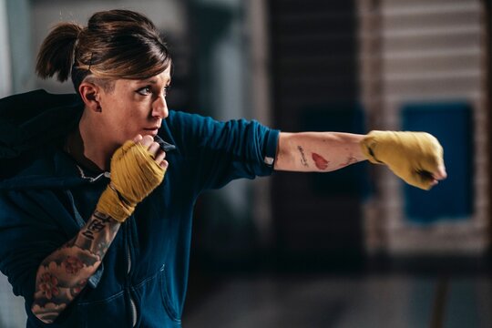 Female boxer punching boxing bag