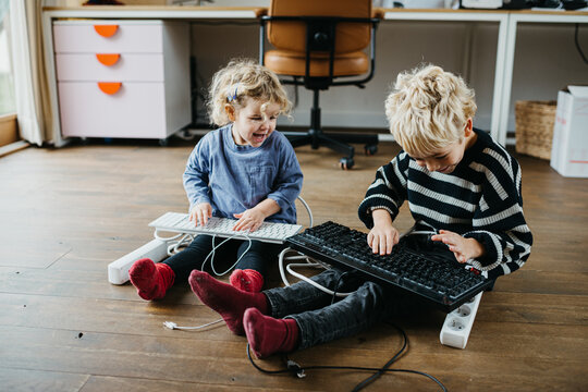 Two Kids having fun time with electrical items