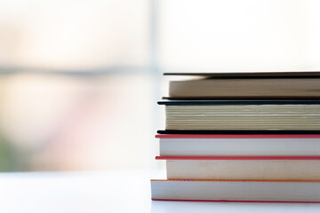 Stack of books by the windw