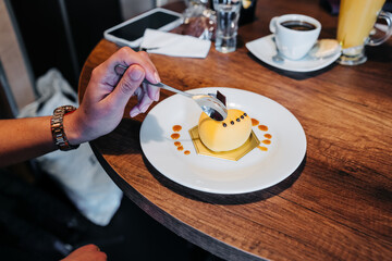 texture detail, eating a heart-shaped cake decorated with yellow icing, restaurant dining, delicious gourmet food