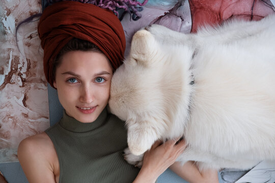 Female illustrator with loyal dog relaxing on floor