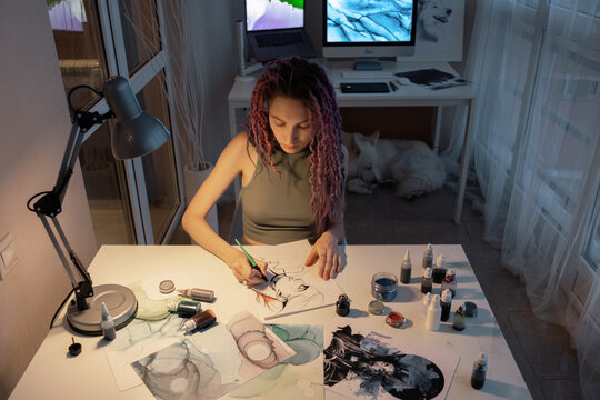 Young woman working in dim studio