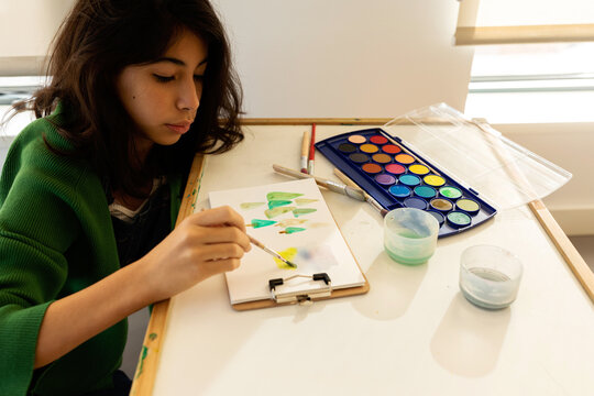 Girl painting with watercolors on a play date