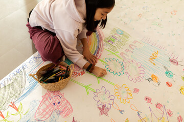 Girl drawing continuous paper on the floor