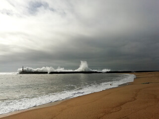 Giant waves breaking on the breakwater and the lighthouse