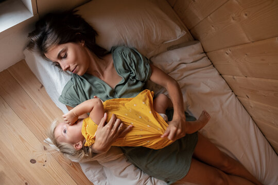 Mom with baby resting on mattress