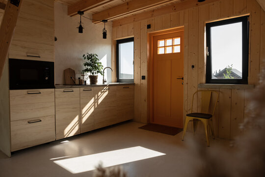 Sunlit kitchen with entrance door and windows