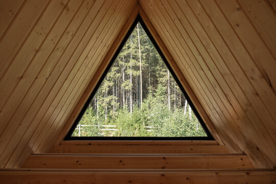 Triangle attic window with forest view