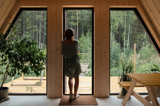 Woman in headphones admiring backyard