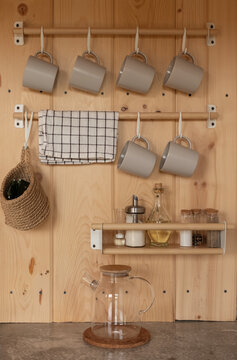 Kitchenware hanging on wooden wall in country kitchen