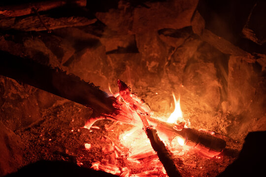 Wooden sticks burning in fire pit