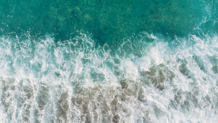 Beach and waves from top view. Turquoise water background from top view. Summer seascape from air. Top view from drone. Travel concept and idea