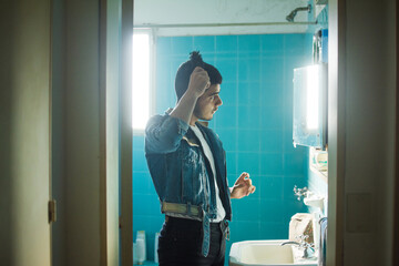 Latino man brushing hair