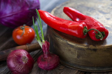 Organic, vegetarian fresh vegetables, red tomato, pepper, cabbage, onion, on wooden background. Food concept. Vintage still life with old cooper
