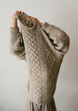 Teenage inside a big wool sweater