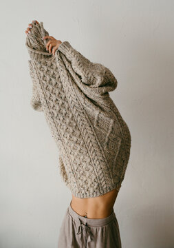 Teenage inside a big wool sweater