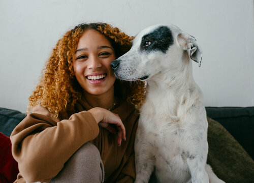 Pretty teenage girl posing with dog
