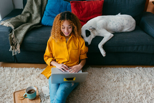 Beautiful girl and dog at home living room 