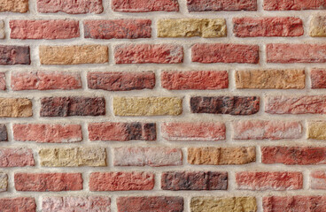 Brick wall. Bricks are karsny, orange color.