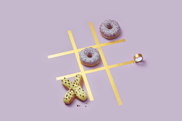 Game of noughts and crosses with donuts and eclairs