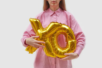 Woman holding balloons of XO letters