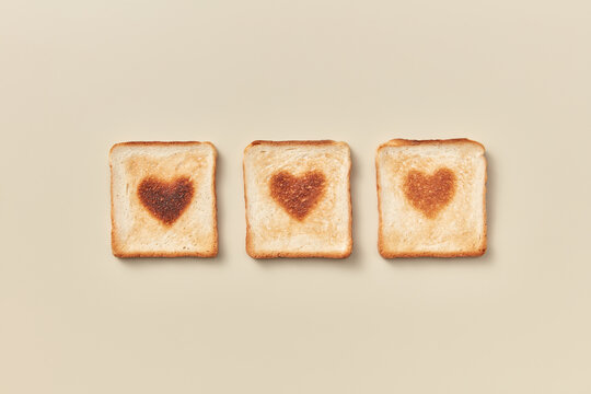 Three toasts with burnt hearts