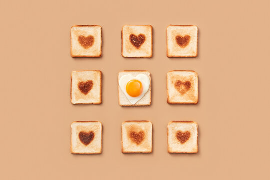 Toasts with burnt hearts and egg