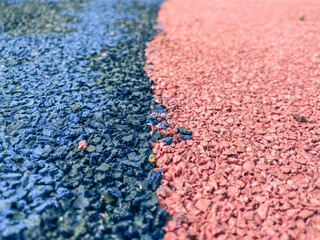 coating for a sports ground, anti-slip floor. blue-pink texture, stones of different colors. background of small, pink and blue stones, which are tightly packed on the road