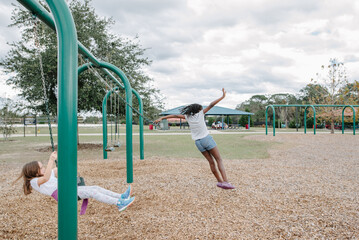 Girl jumping of a swing