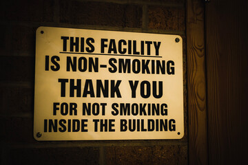 A warning sign announcing that the facility is non-smoking inside, posted to the facility's brick wall in Chardon, Ohio