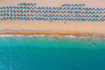 Beach with umbrellas on the Mediterranean Sea. Wtd from a drone. Aerial photography