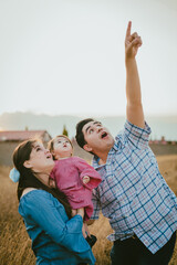 Fototapeta premium Hispanic family enjoying nature look at the sky in amazement