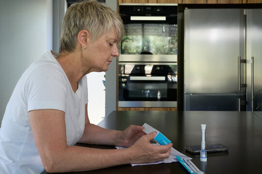 Woman holding a at home covid test kit