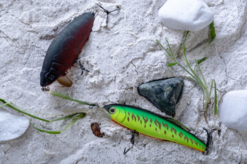 Different lures for fishing in the sand. Wobblers for catching predatory fish. Hard lures in the sand.