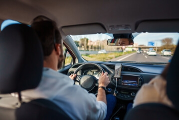 Man driver using phone with mobile navigation