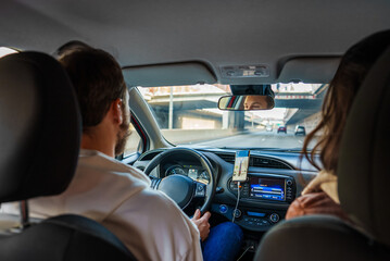 Couple driving on highway with mobile gps navigation