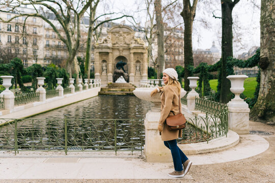 Woman walking in historical park in autumn