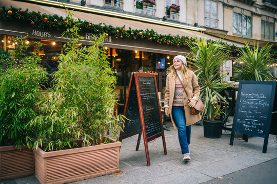 Woman leaving cafe in in old city center
