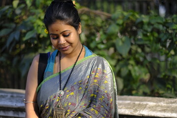 Portrait of a young lady looking downwards at outdoors