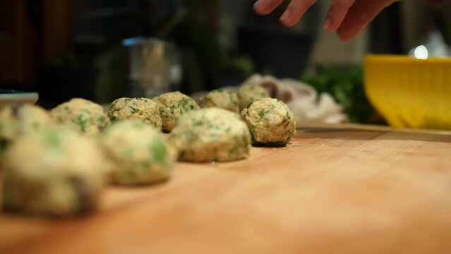 Woman's hand preparing dumplings with accuracy. Row Balls. Tyrolean specialties. Slow Motion 4K