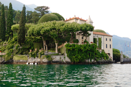 Elegant building near lush gardens and lake water