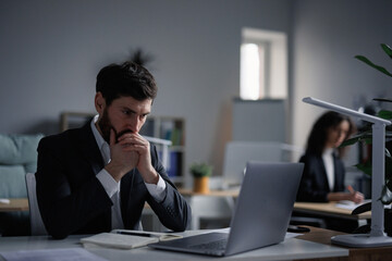 Anxiety male worker while playing stock market online
